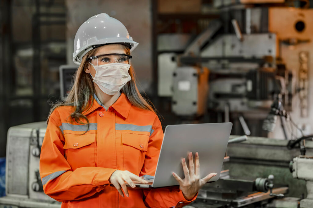 Portrait,of,engineer,wearing,the,face,mask,and,holding,laptop